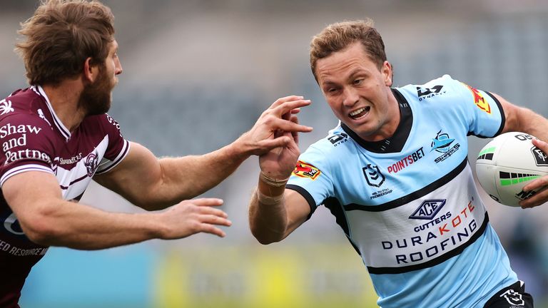 Matt Moylan is tackled by Brendan Elliot of Manly Sea Eagles 