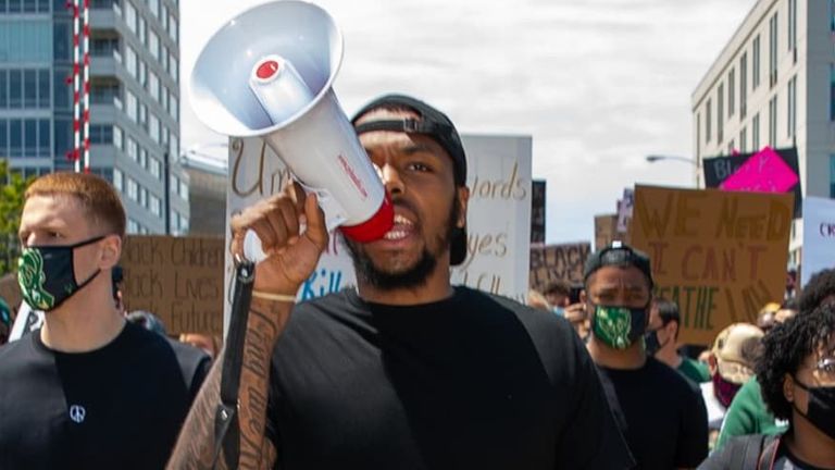 Sterling Brown leads his Bucks' team-mates during a protest against racial injustice in Milwaukee - credit nba.com