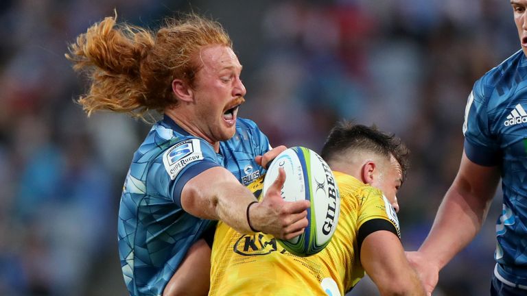 Tom Robinson looks to offload the ball against the Hurricanes