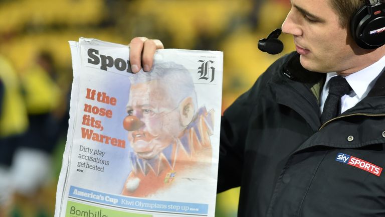 Alex Payne holds up the New Zealand Herald which depicted  Warren Gatland as a clown

went too far 