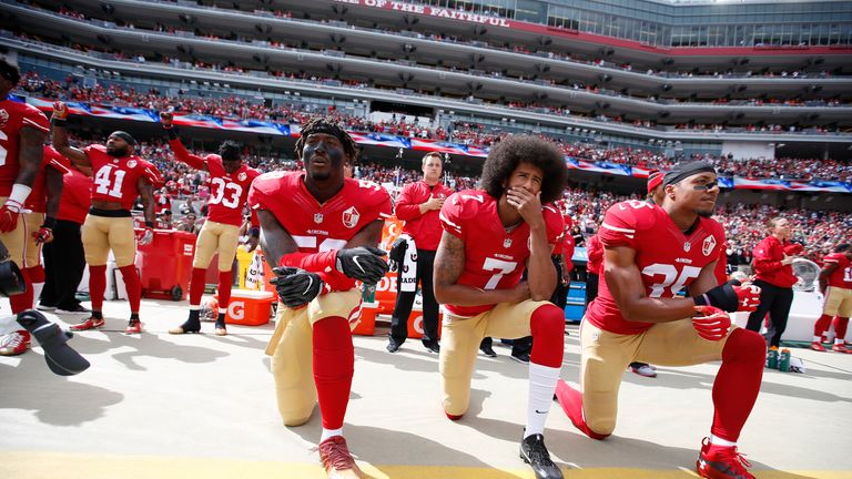 Colin Kaepernick (centre) has not played in the NFL since 2016 when he gained widespread attention for 'taking a knee'