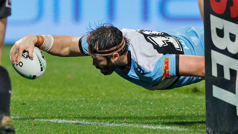 Aaron Woods goes over for a try for the Sharks