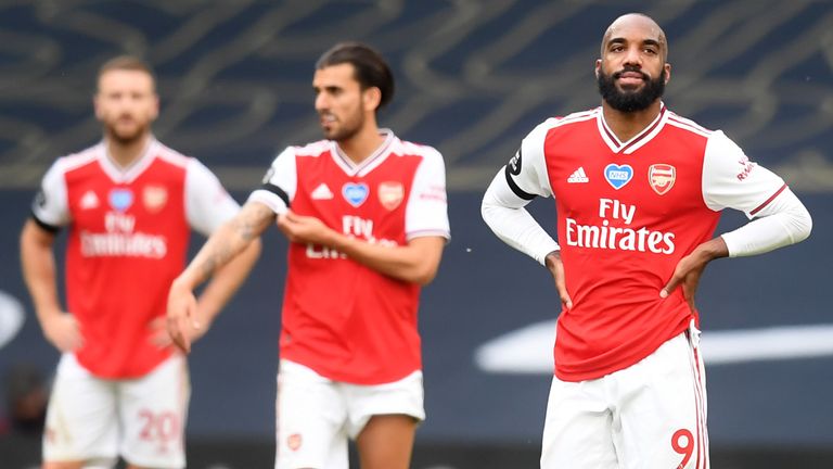 Arsenal's Alexandre Lacazette (right) appears dejected after Tottenham Hotspur's Toby Alderweired scores
