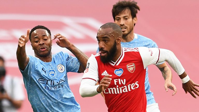 Alexandre Lacazette gets past Raheem Sterling