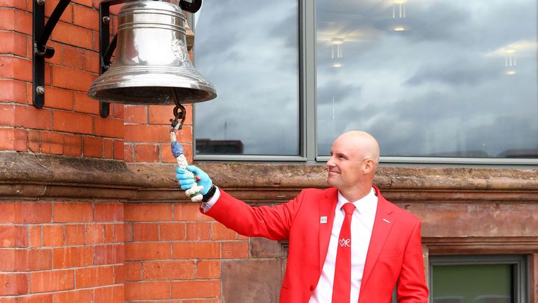 Sir Andrew Strauss rings the five-minute bell at Emirates Old Trafford on day one of the Ruth Strauss Foundation Test