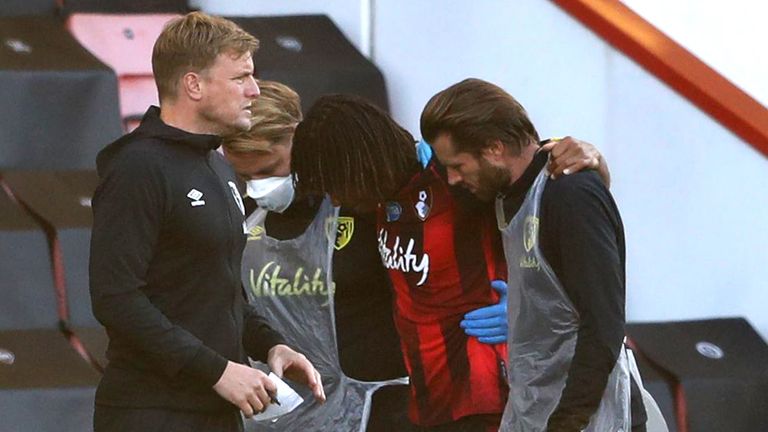 Bournemouth defender Nathan Ake is helped off the pitch after he was injured against Leicester
