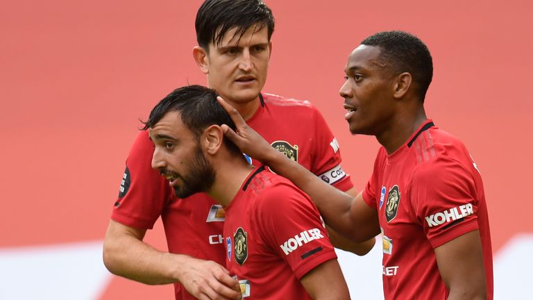 Bruno Fernandes is congratulated by Harry Maguire and Anthony Martial (right) after scoring against Bournemouth