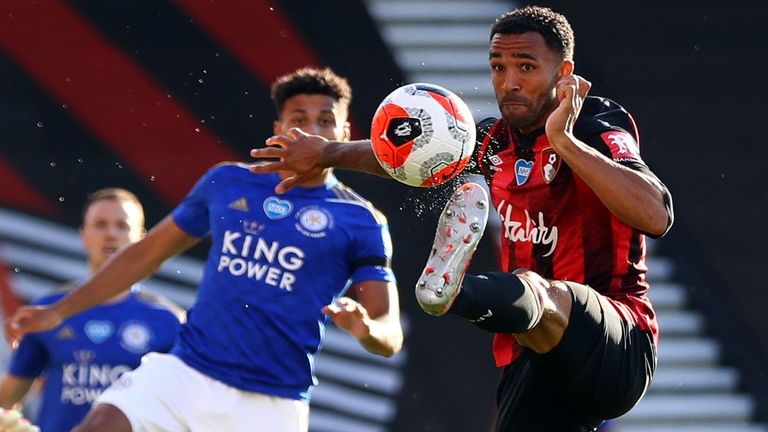 Bournemouth's striker Callum Wilson (R) stretches for the ball against Leicester