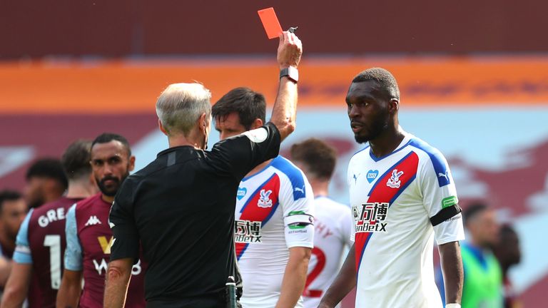 Christian Benteke is shown a red card by Martin Atkinson