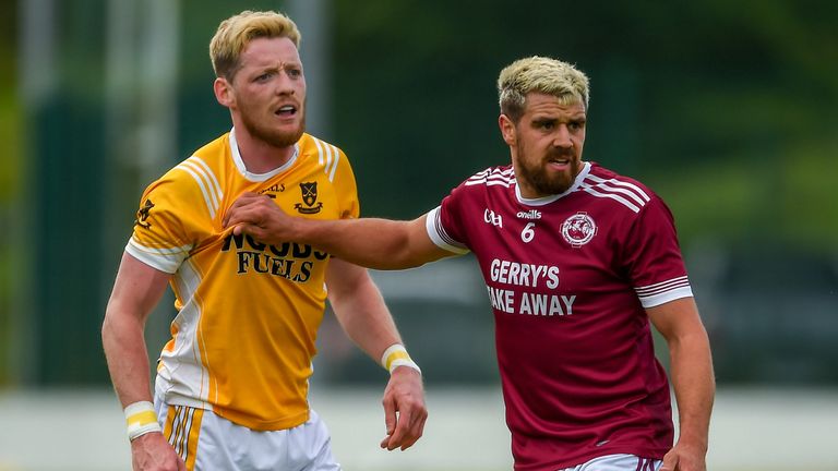 Conor McManus of Clontibret is held by Drew Wylie of Ballybay