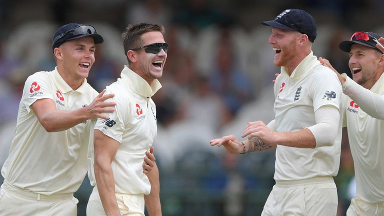 England's Joe Denly celebrates taking the wicket of South Africa's Dean Elgar at Cape Town