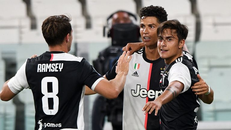 TURIN, ITALY - JULY 20: Cristiano Ronaldo of Juventus celebrates goal with teammates Paulo Dybala of Juventus (R) and Aaron Ramsey of Juventus (L) during the Serie A match between Juventus and SS Lazio at Allianz Stadium on July 20, 2020 in Turin, Italy. (Photo by Chris Ricco/Getty Images)