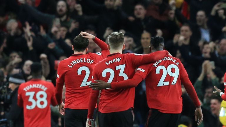 Manchester United players salute the crowd after winning the English Premier League football match between Manchester City and Manchester United at the Etihad Stadium in Manchester, north west England, on December 7, 2019.