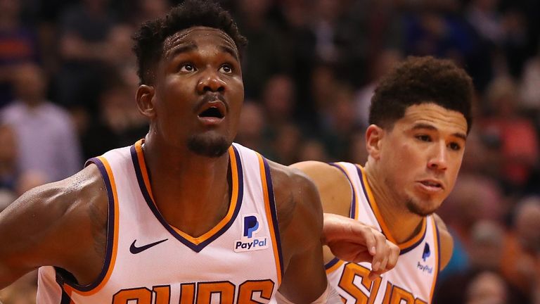 DeAndre Ayton and Devin Booker in action for Phoenix against Milwaukee