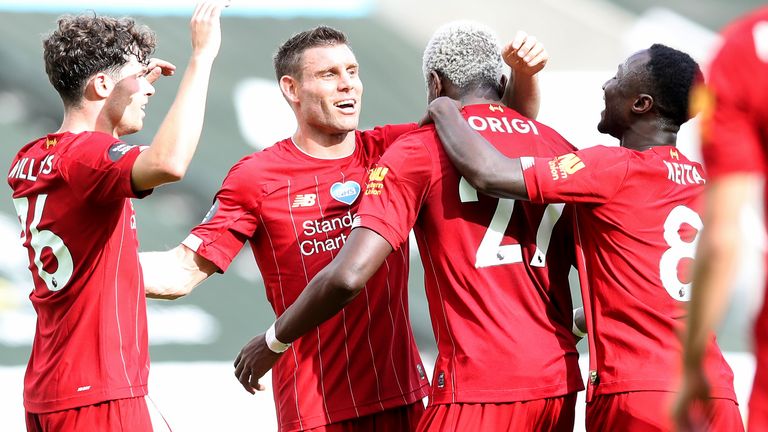 Divock Origi is mobbed by teammates after putting Liverpool 2-1 up