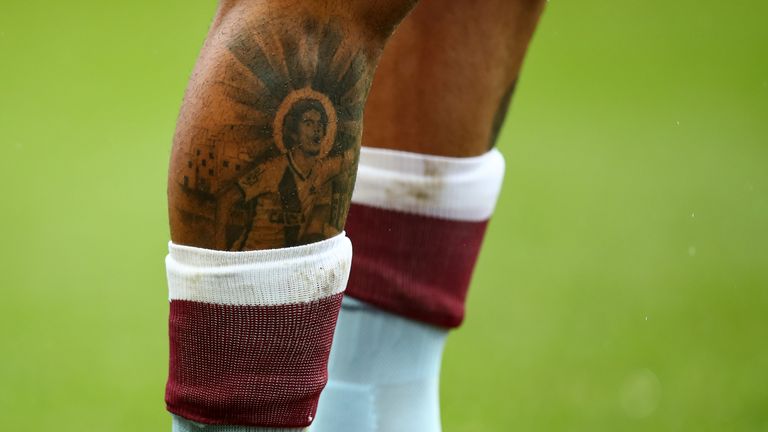 Douglas Luiz sports a tattoo on his right leg