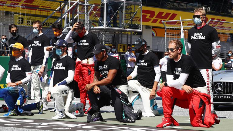 Lewis Hamilton of Great Britain and Mercedes GP and some of the F1 drivers take a knee on the grid in support of the Black Lives Matter movement ahead of the Formula One Grand Prix of Austria at Red Bull Ring on July 05, 2020 in Spielberg, Austria.