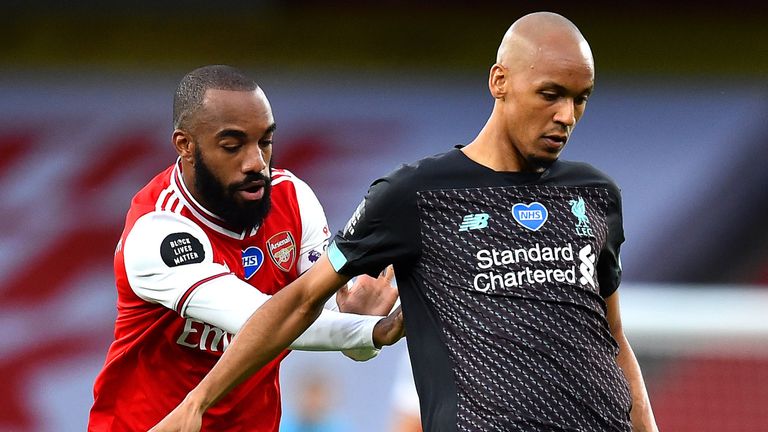 Fabinho is challenged by Arsenal forward Alexandre Lacazette