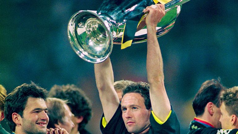 Lambert holds aloft the Champions League trophy after winning with Dortmund in 1997