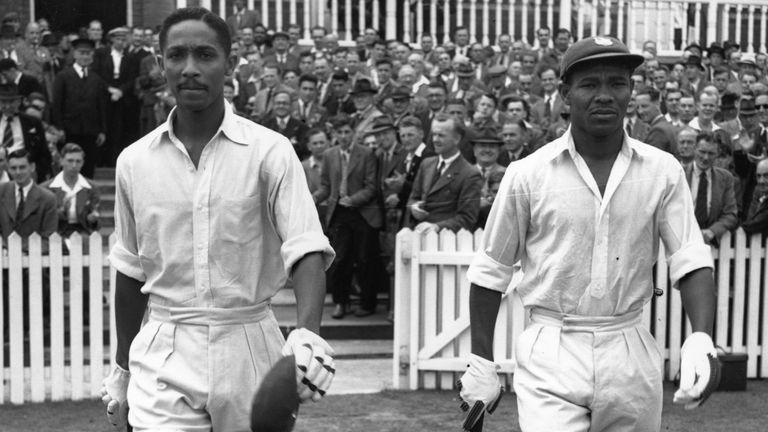 West Indies cricketers Frank Worrell (1924 - 1967) (left), and Everton Weekes go out to resume their record-making innings against England at Trent Bridge. 