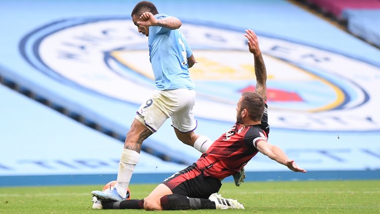 Gabriel Jesus lands on the foot of Steve Cook as the on-field call is overturned