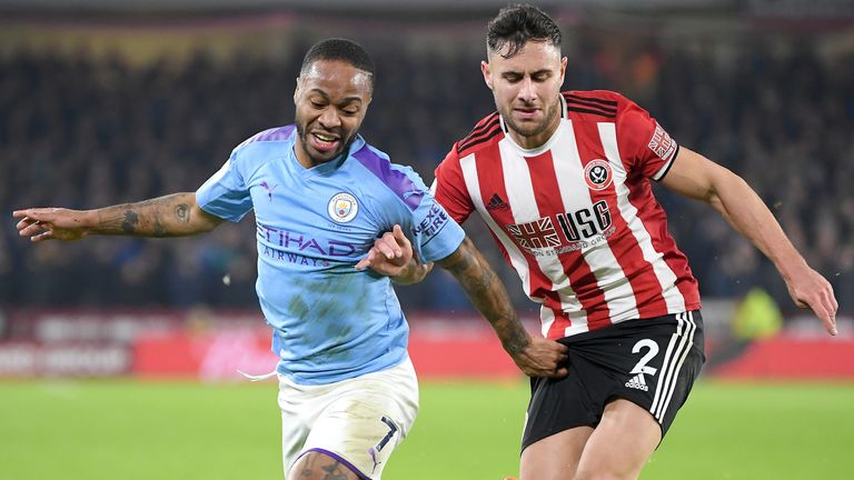 George Baldock tussles with Manchester City's Raheem Sterling