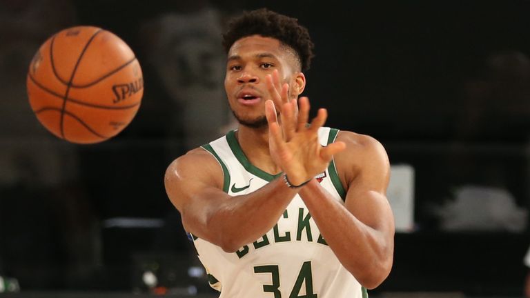 Giannis Antetokounmpo passes to Brook Lopez during a Milwaukee Bucks pre-restart scrimmage game