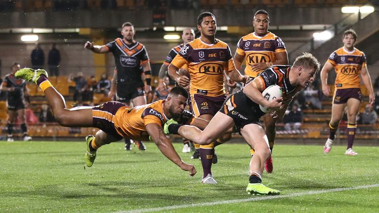 SYDNEY, AUSTRALIA - JULY 17: Harry Grant of the Wests Tigers crosses the line for a try during the round 10 NRL match between the Wests Tigers and the Brisbane Broncos at Leichhardt Oval on July 17, 2020 in Sydney, Australia. (Photo by Cameron Spencer/Getty Images)