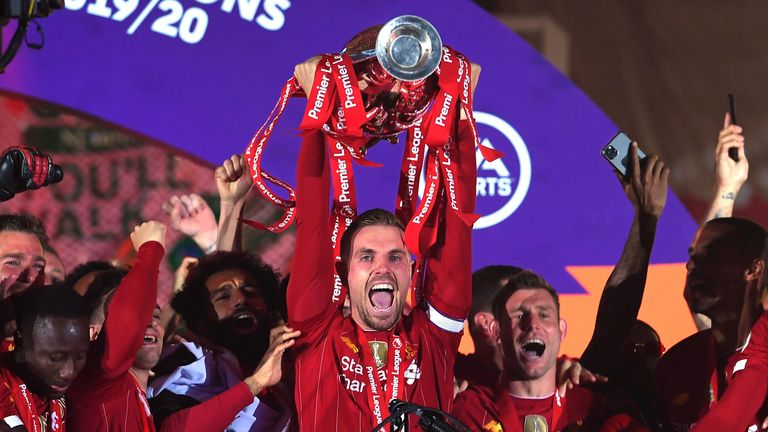 Liverpool captain Jordan Henderson lifts the Premier League trophy