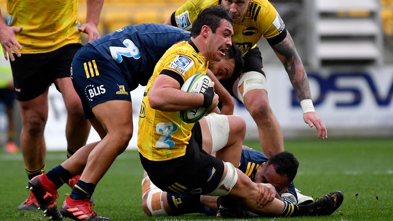 WELLINGTON, NEW ZEALAND - JULY 12: Devan Flanders of the Hurricanes Is tackled during the round 5 Super Rugby Aotearoa match between the Hurricanes and the Highlanders at Sky Stadium on July 12, 2020 in Wellington, New Zealand. (Photo by Masanori Udagawa/Getty Images)