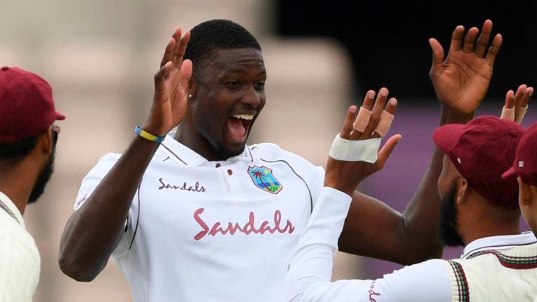 West Indies' Jason Holder (C) celebrates taking the wicket of England's Jofra Archer on the second day of the first Test cricket match between England and the West Indies at the Ageas Bowl in Southampton, southwest England on July 9, 2020. 