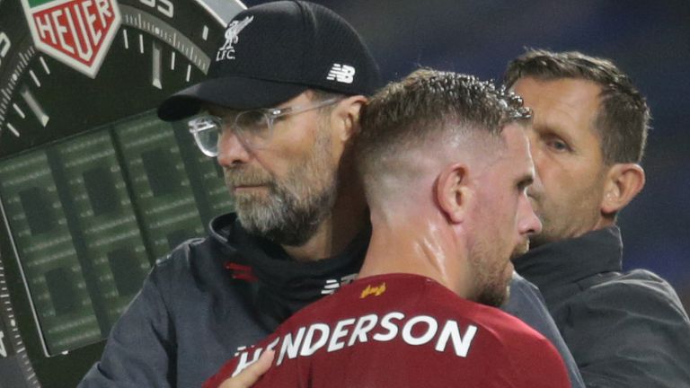 Jordan Henderson receives a pat on the back from manager Jurgen Klopp as he is substituted 