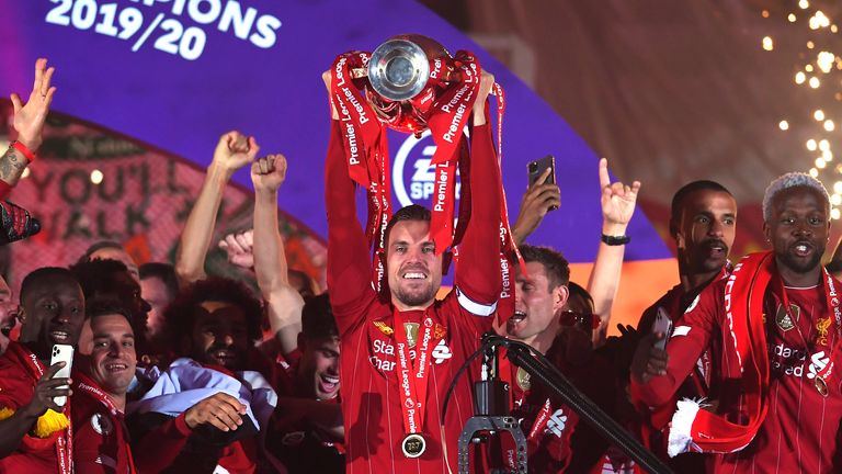 LIVERPOOL, ENGLAND - JULY 22: Jordan Henderson of Liverpool lifts The Premier League trophy following the Premier League match between Liverpool FC and Chelsea FC at Anfield on July 22, 2020 in Liverpool, England.