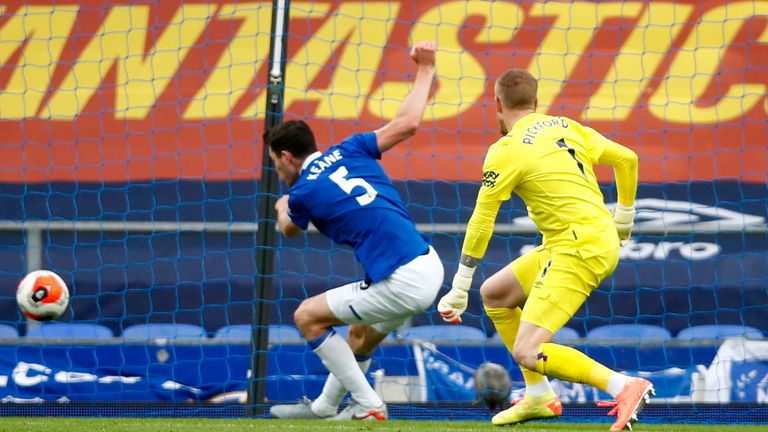 Jordan Pickford watches as team mate Michael Keane of Everton clears the ball from the line during the Premier League match between Everton FC and Leicester City at Goodison Park on July 01, 2020 in Liverpool, England. Football Stadiums around Europe remain empty due to the Coronavirus Pandemic as Government social distancing laws prohibit fans inside venues resulting in all fixtures being played behind closed doors