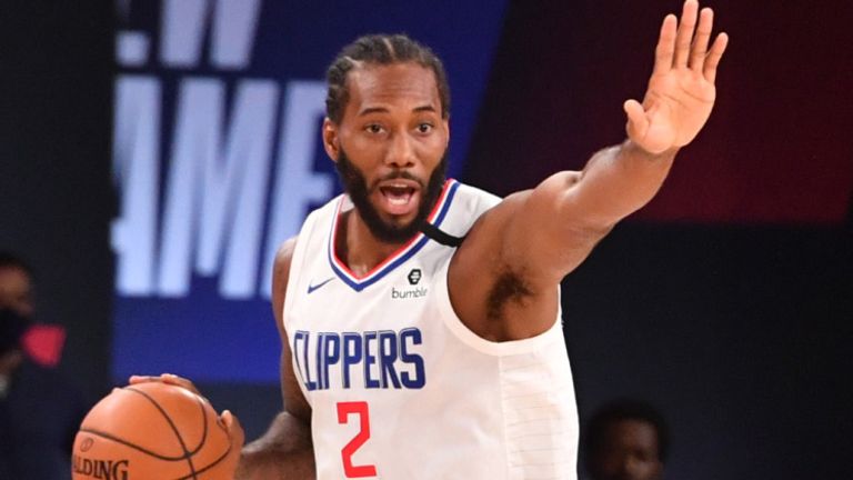 Kawhi Leonard handles the ball in the Clippers' opening scrimmage game against the Magic