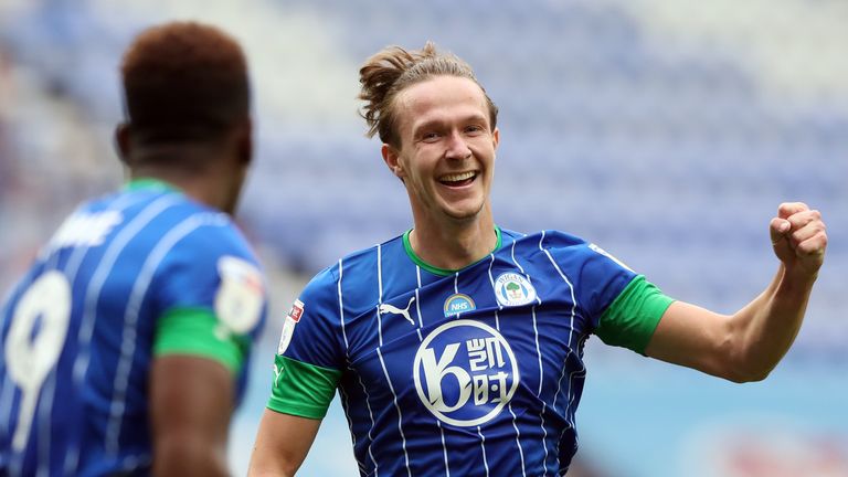 Kieran Dowell celebrates his second and Wigan's sixth after 42 minutes