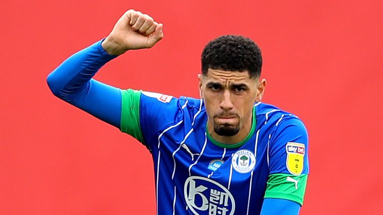 Leon Balogun takes a knee in support of the Black Lives Matter movement ahead of a game for Wigan