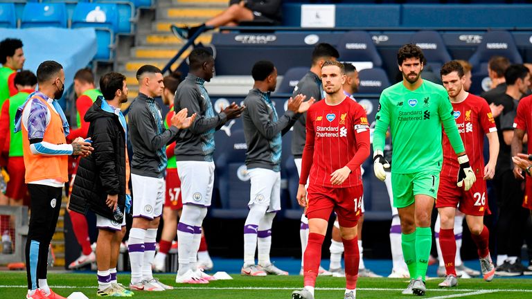 Manchester City players form a guard of honour for the Liverpool players as they make their way onto the pitch after capturing the league title last week, ahead of the English Premier League football match between Manchester City and Liverpool at the Etihad Stadium in Manchester,