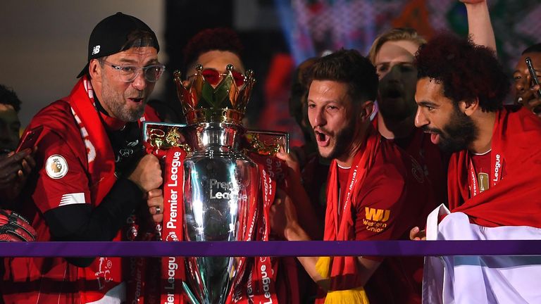 Jurgen Klopp lifts the Premier League trophy with Adam Lallana and Mohamed Salah