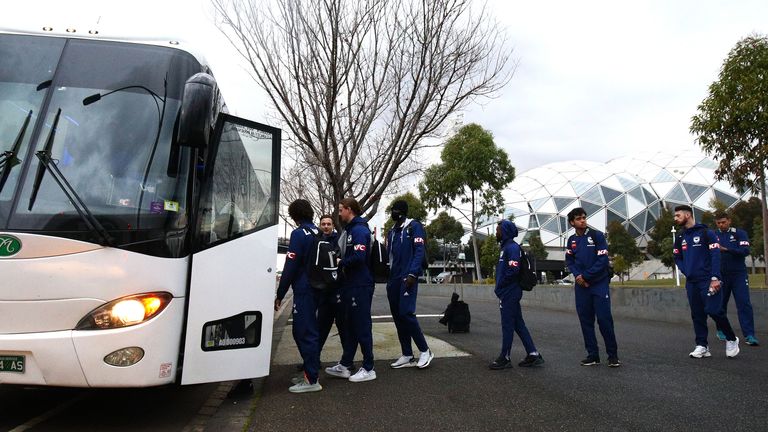 Melbourne Victory players board a bus as they head for a flight out of Victoria