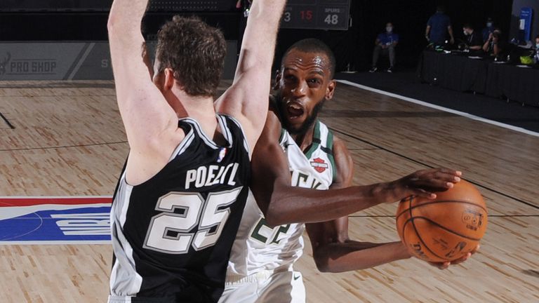 Khris Middleton goes airborne against the San Antonio Spurs