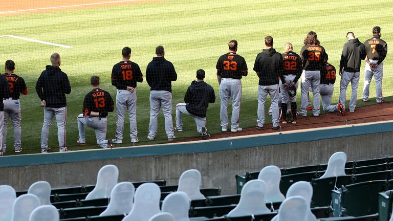 Three San Francisco Giants players took a knee while others remained standing during the national anthem