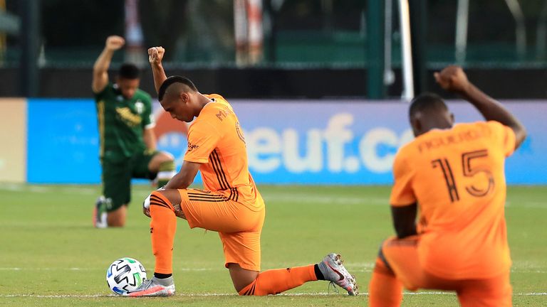 Players from Houston Dynamo and Portland Timbers take a knee at the MLS is Back tournament in Florida