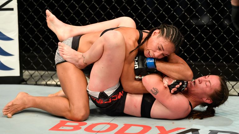 Molly McCann gets an elbow from Talia Santos during their flyweight fight