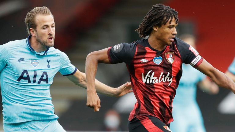 Nathan Ake holds off the challenge of Harry Kane