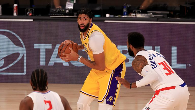 Anthony Davis #3 of the Los Angeles Lakers looks to pass against Marcus Morris Sr. #31 of the LA Clippers during the third quarter of the game at The Arena at ESPN Wide World Of Sports Complex on July 30, 2020 in Lake Buena Vista, Florida.