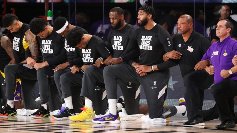 LeBron James kneels alongside Anthony Davis