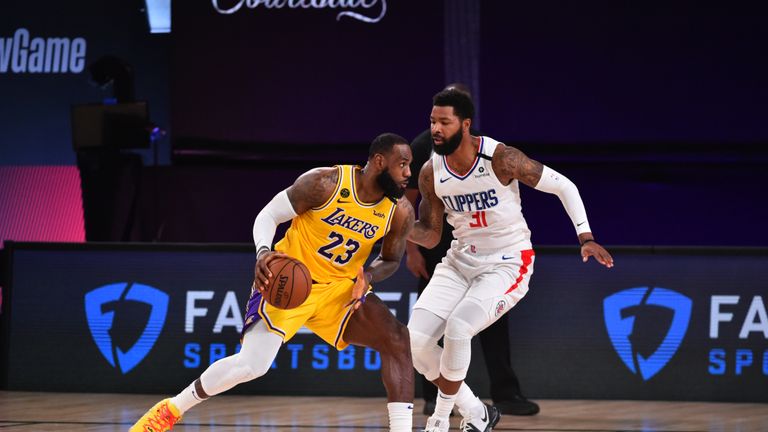 LeBron James #23 of the Los Angeles Lakers handles the ball against Marcus Morris Sr. #31 of the LA Clippers on July 30, 2020 at The Arena at ESPN Wide World Of Sports Complex in Orlando, Florida.