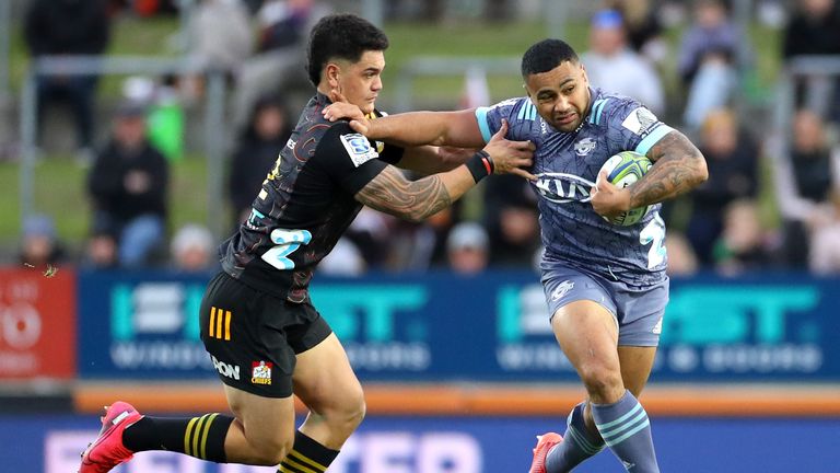 Ngani Laumape of the Hurricanes fends off Tumua Manu of the Chiefs