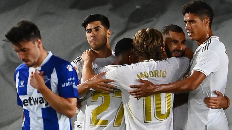 Real Madrid players celebrate Karim Benzema's opening goal against Alaves